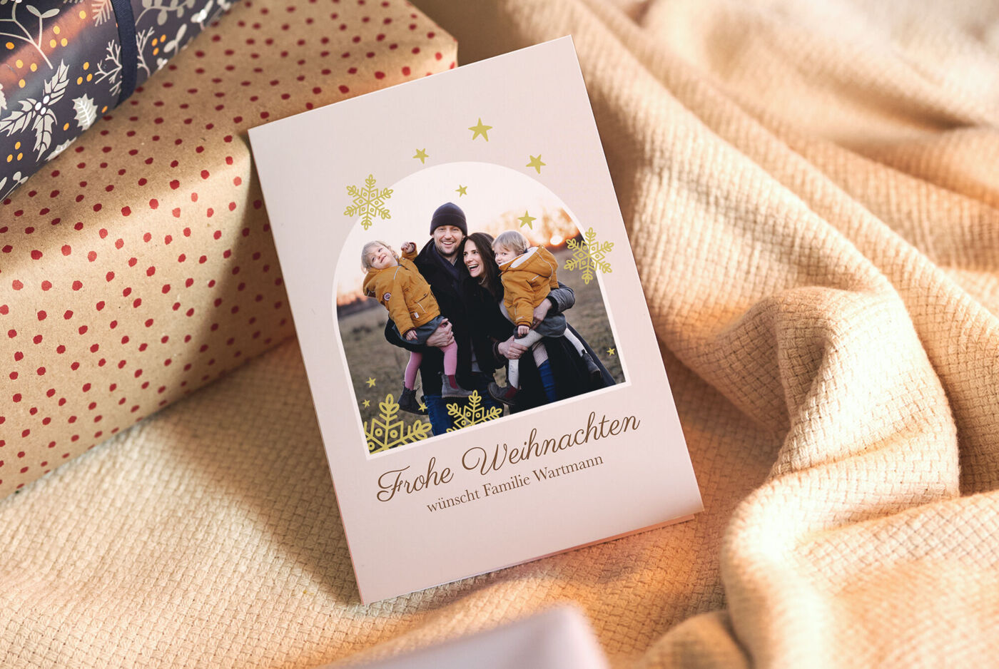 Festliche Weihnachtskarte mit fröhlicher Familie im Vordergrund.